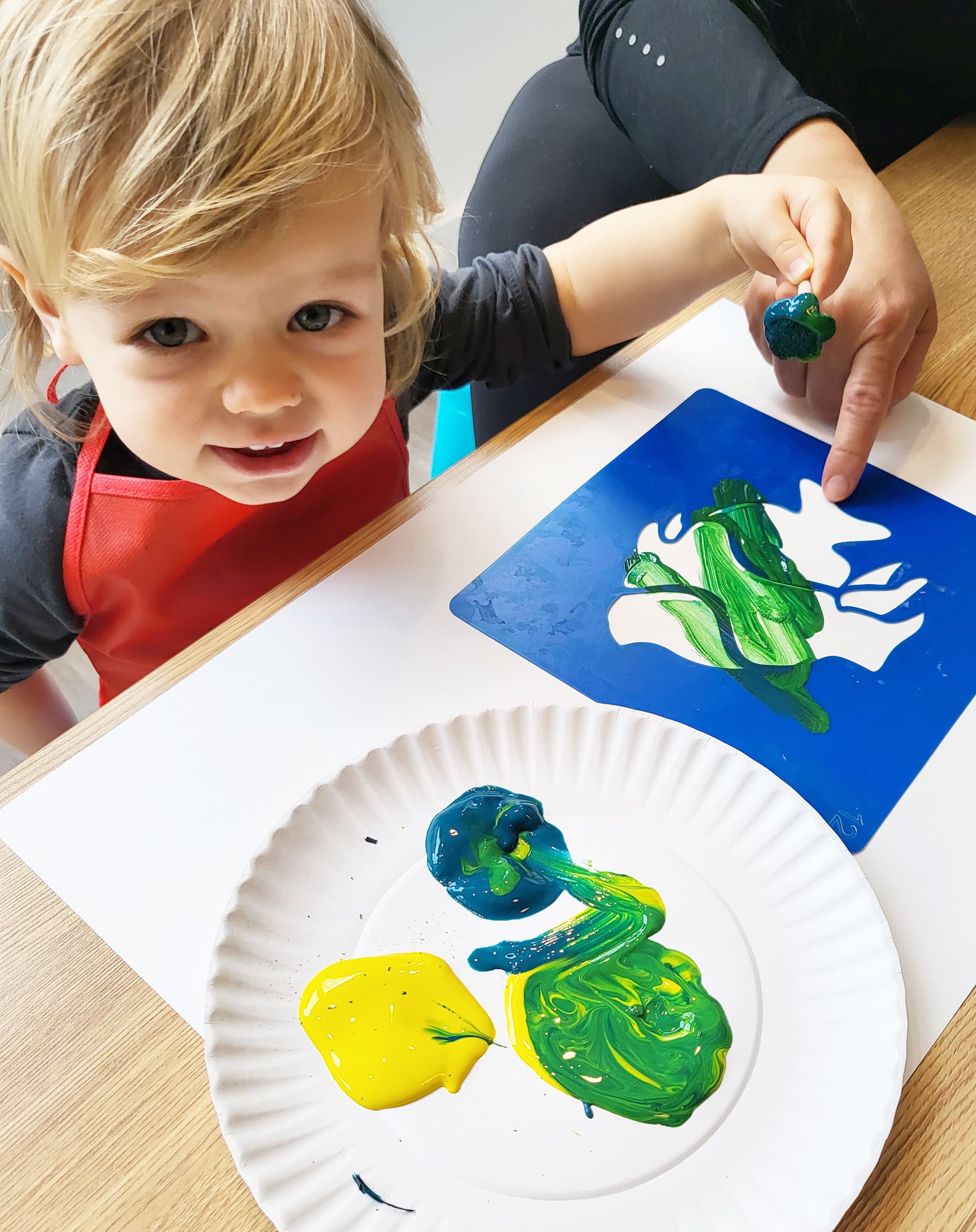 Toddler painting at PLAYDAY