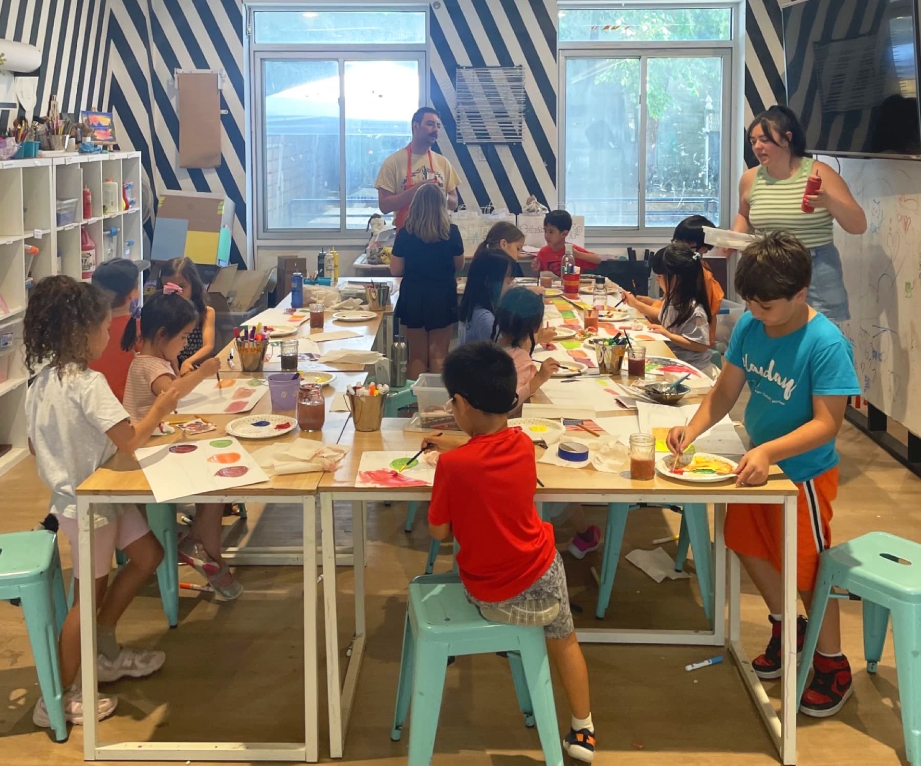 PLAYDAY teaching artists working the studio floor during a class