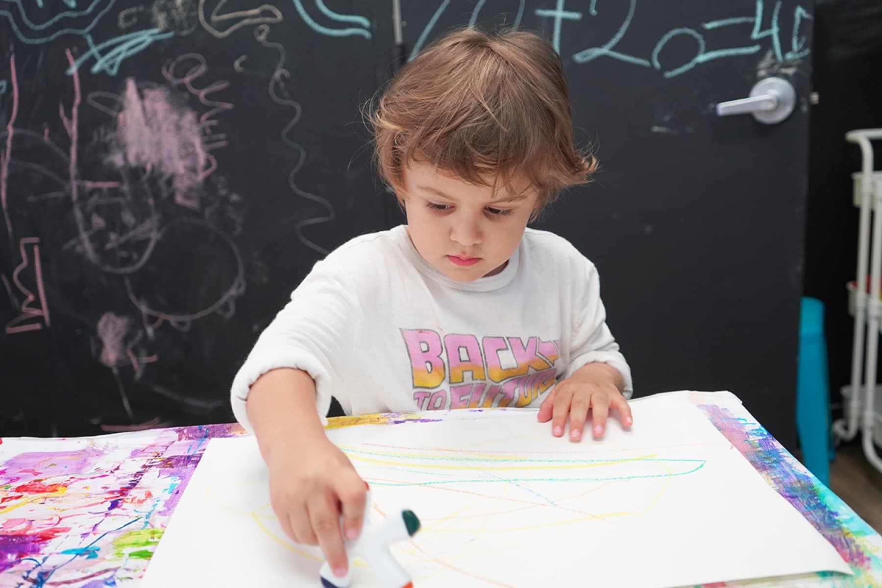 A child drawing at PLAYDAY