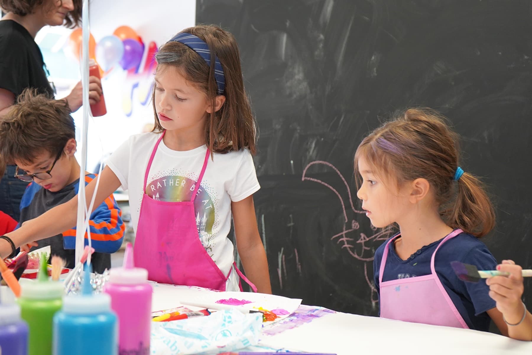 Children painting together at a PLAYDAY birthday party